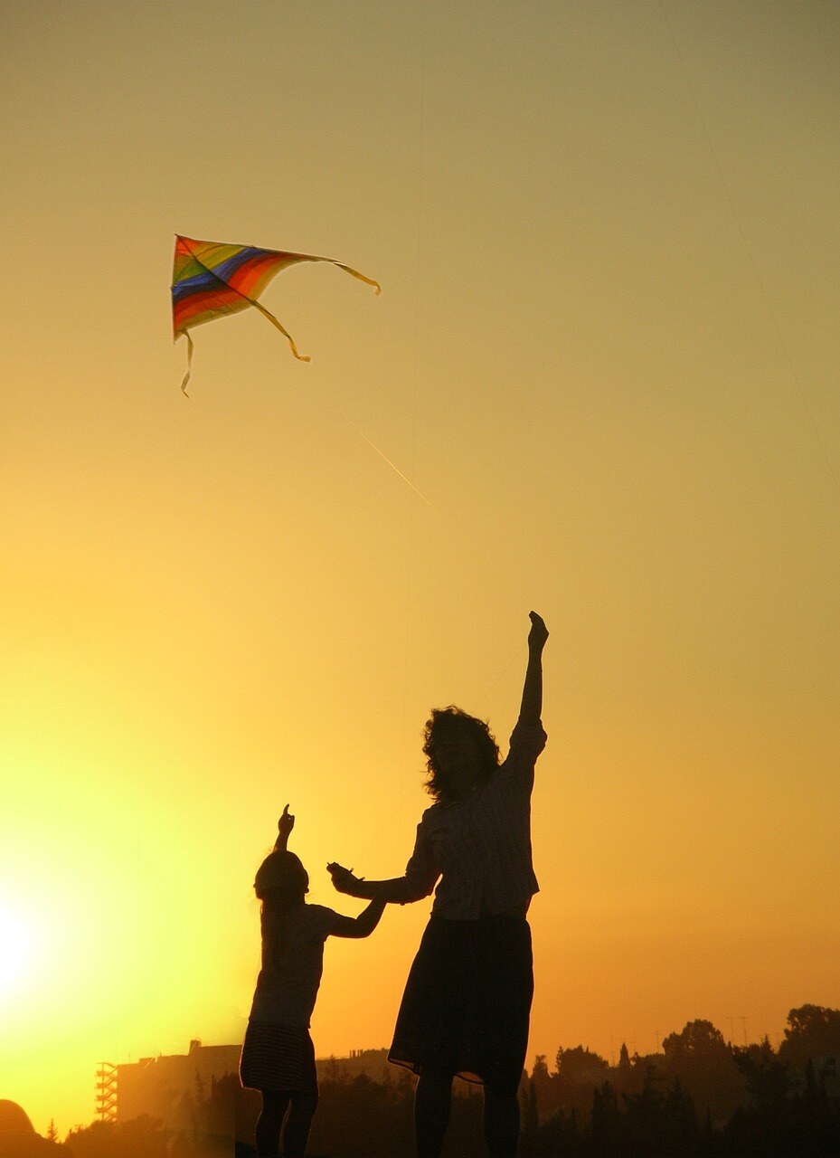 mom and kid flying kite